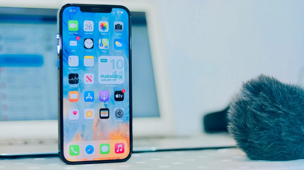 Smartphone displaying apps, notifications and time close-up indoors.